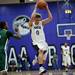 Pioneer High School senior William Kirchen jumps through defenders in the game against Huron on Friday, Jan. 18. Pioneer leads at halftime 36-24. Daniel Brenner I AnnArbor.com
